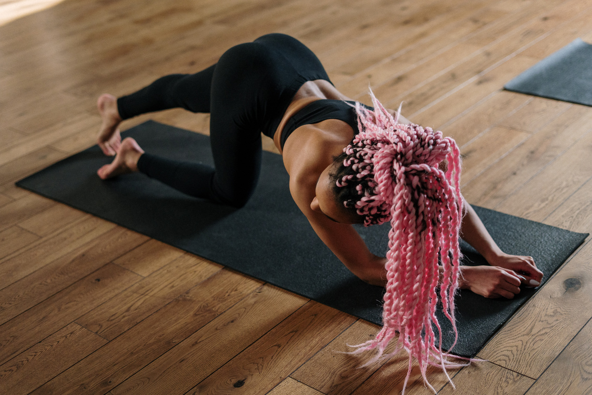 Woman in Black Tank Top and Black Leggings Doing Yoga